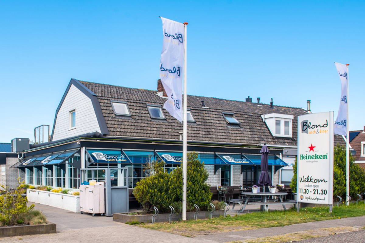 Buitenkant van Restaurant Blond Lunch & Diner met een wapperende vlag.